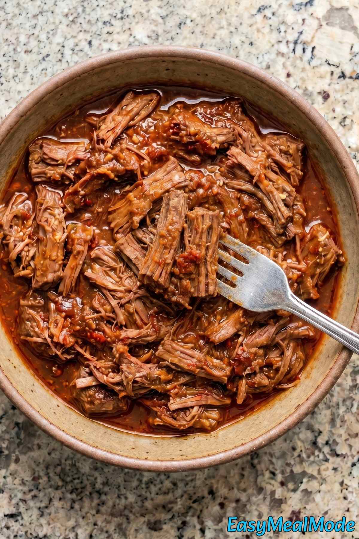 Rich slow cooker barbacoa beef in bowl