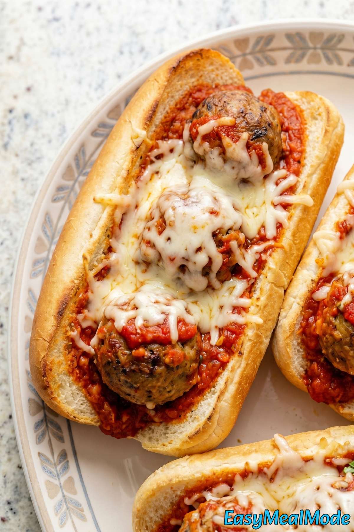 Cheesy slow cooker meatball subs on a tray